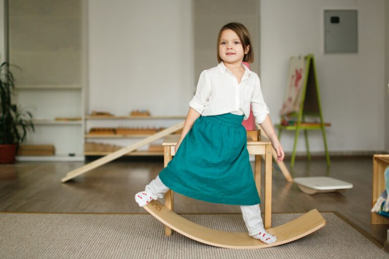 child girl in a linen apron sways on balancing board
