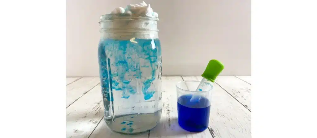 Fill a clear jar with water and top it with shaving cream to represent a cloud. Drop food coloring onto the shaving cream and watch as the "rain" falls through the cloud and into the water below.